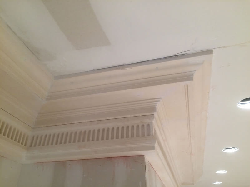Ornamental plaster cornices added to dining room walls and ceiling, before being painted.