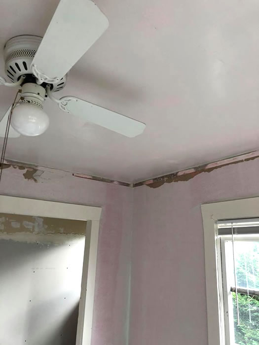 Ceiling and wall plaster damage.